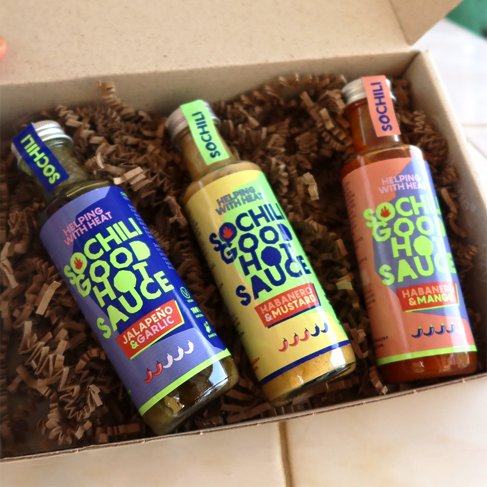 A box containing three bottles of Sochili hot sauce labeled and put in packaging box.