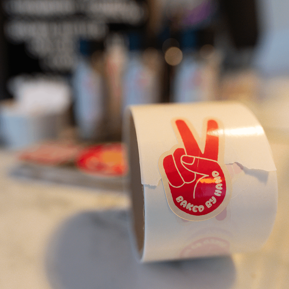 die cut labels on roll with victory hand