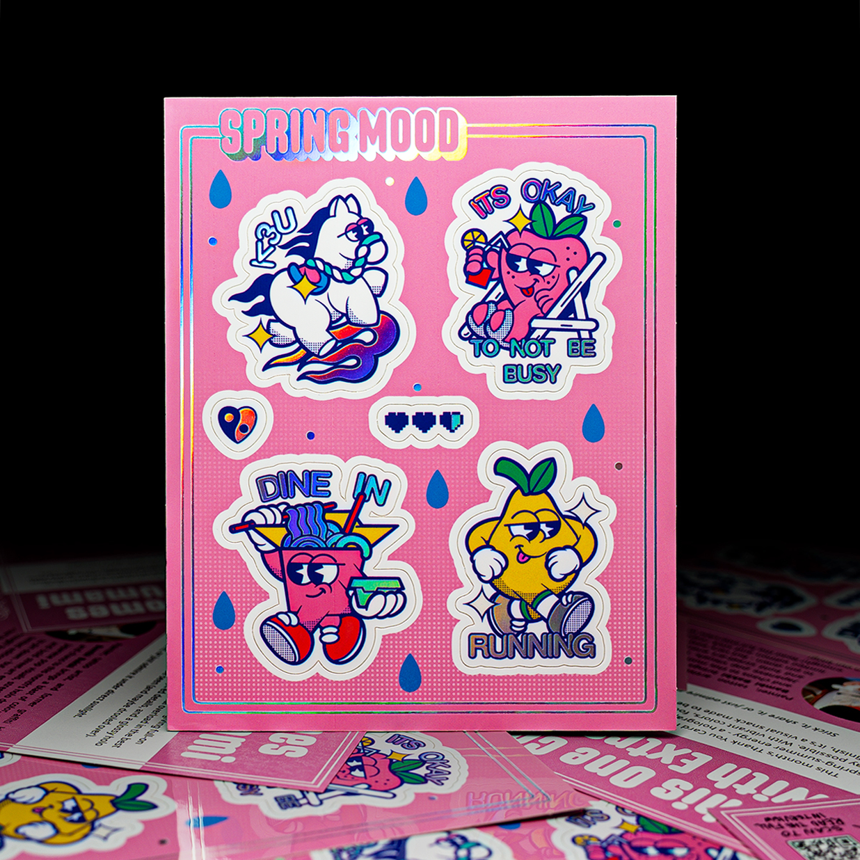 Colorful holographic sticker sheets on a pink background featuring cartoon characters.