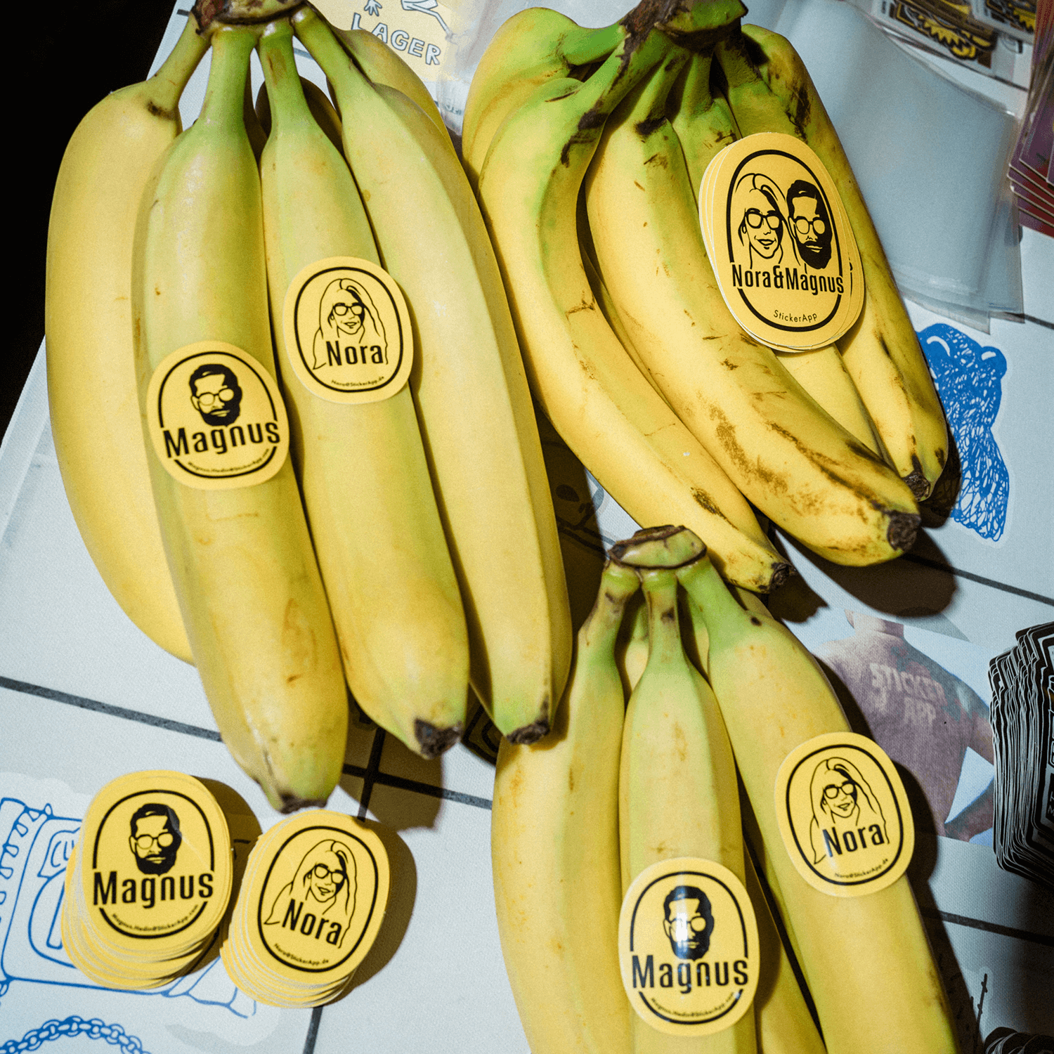 Bananas with yellow die cut vinyl stickers featuring with the names "Magnus" and "Nora".