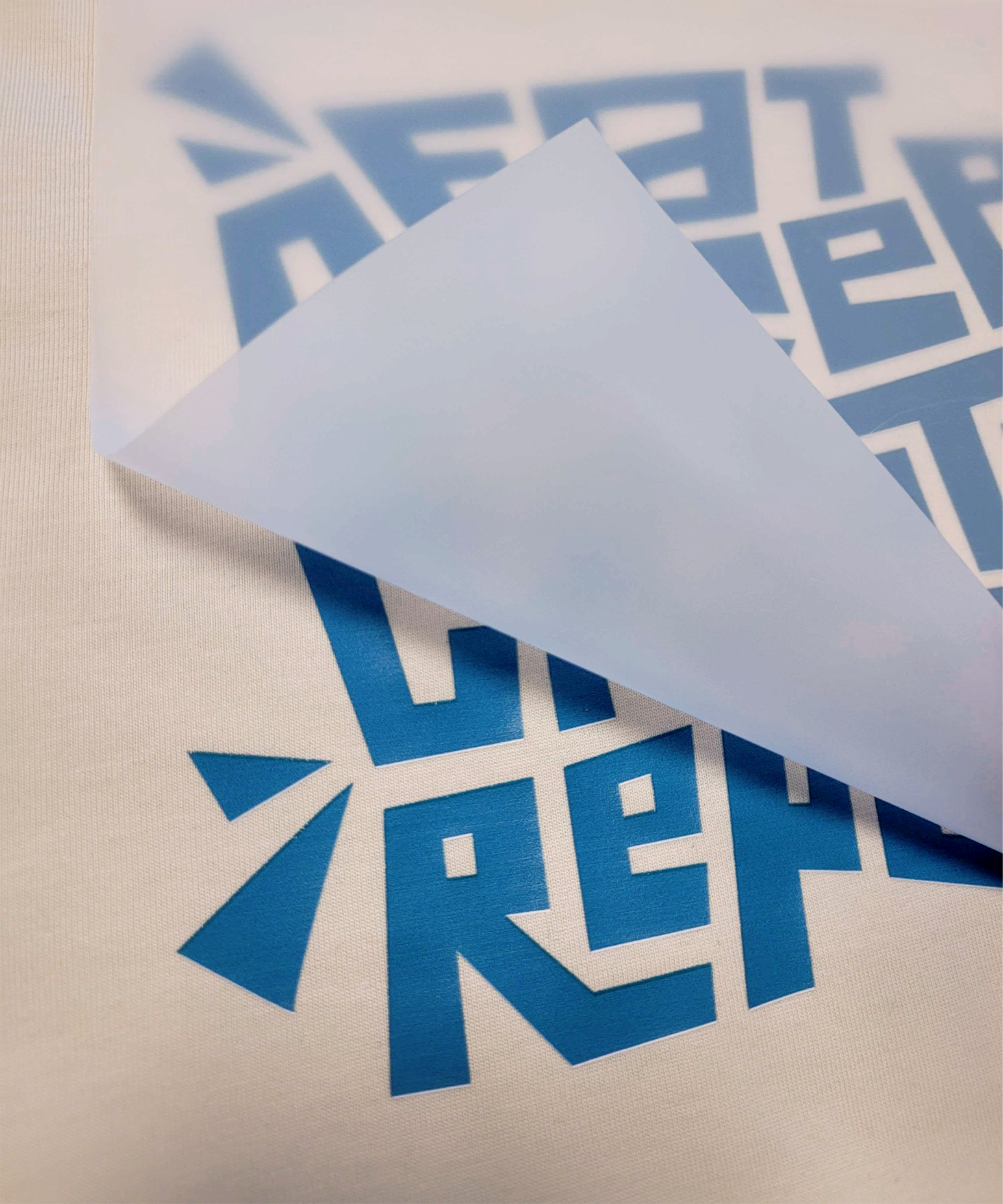 DTF heat transfer being applied to a t-shirt.