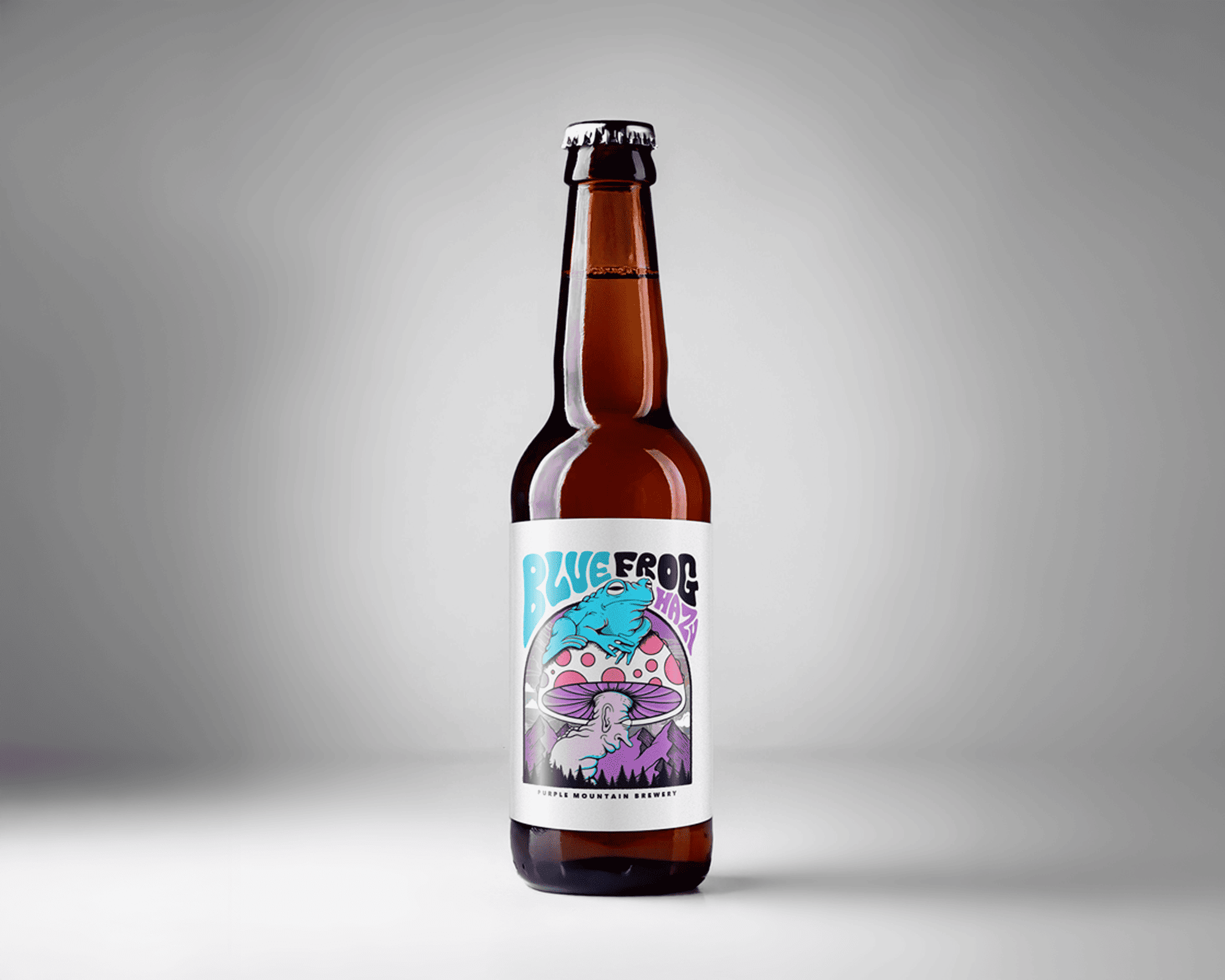 A brown glass bottle of "Blue Frog" craft beer with a colorful label featuring a blue frog on a mushroom, set against a gray background.