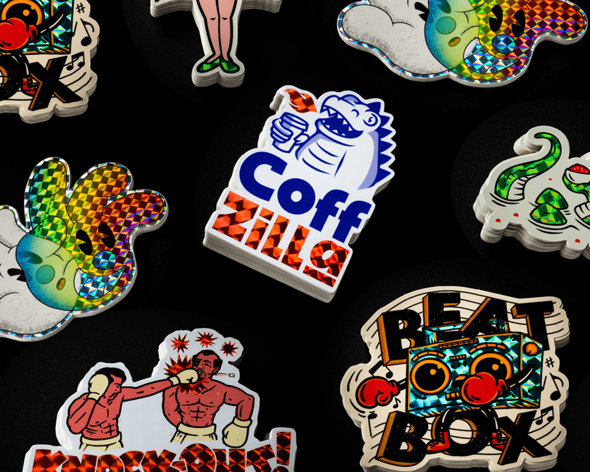 A collection of vibrant, colorful prismatic stickers featuring various designs including a dinosaur, boxers, and abstract patterns on a black background.
