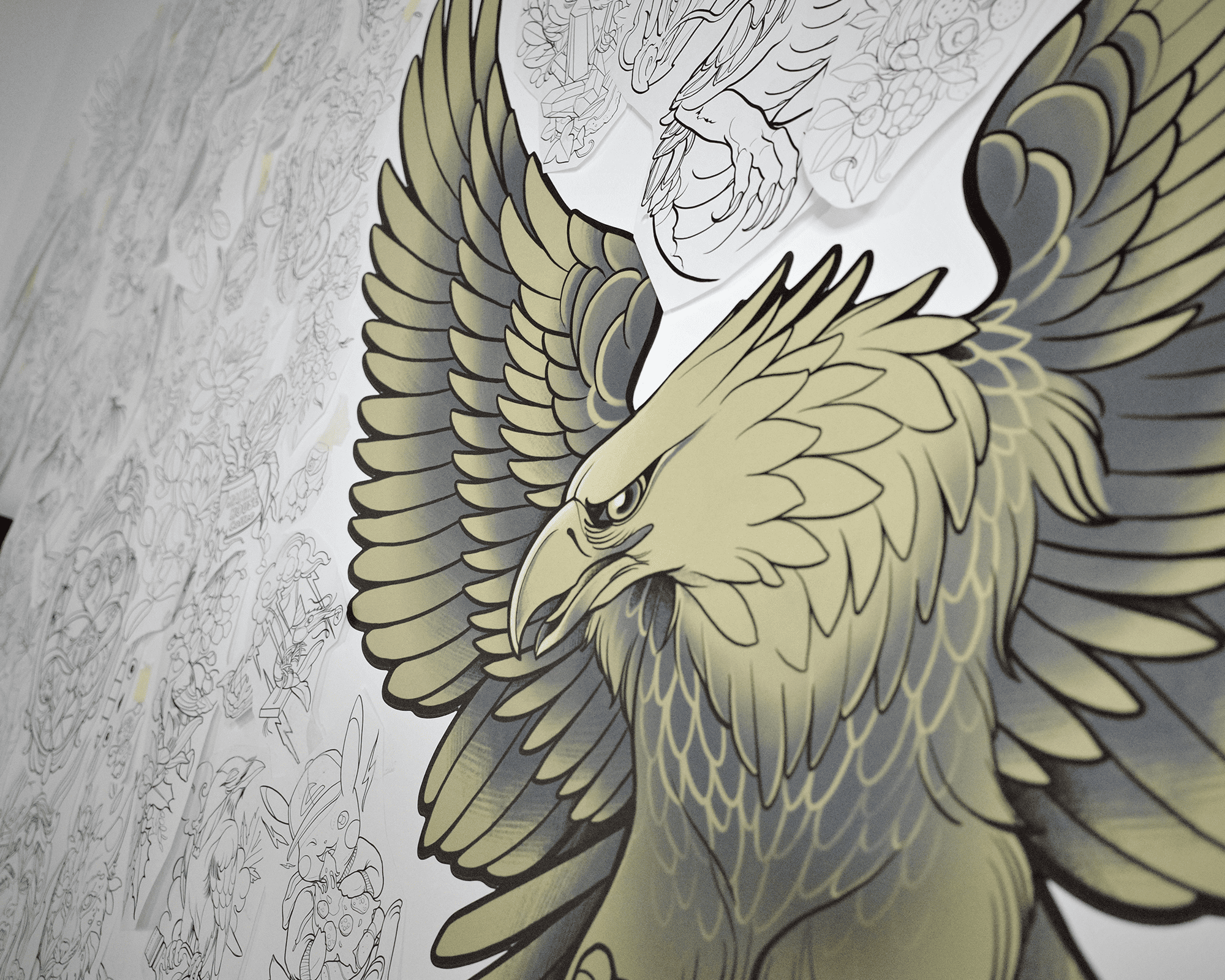 wall sticker of eagle with outstretched wings on a wall, surrounded by various detailed sketches in the background.