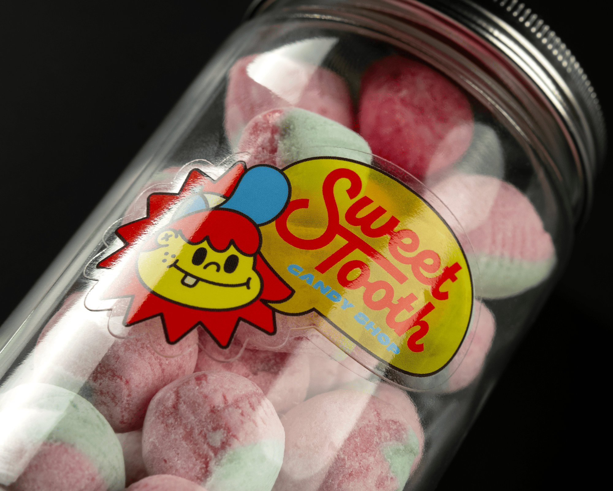 Jar of pink and green marshmallows with a "Sweet Tooth Candy Shop" clear label featuring a cartoon character.