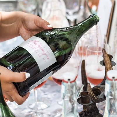 Custom champagne wedding stickers on a bottle.