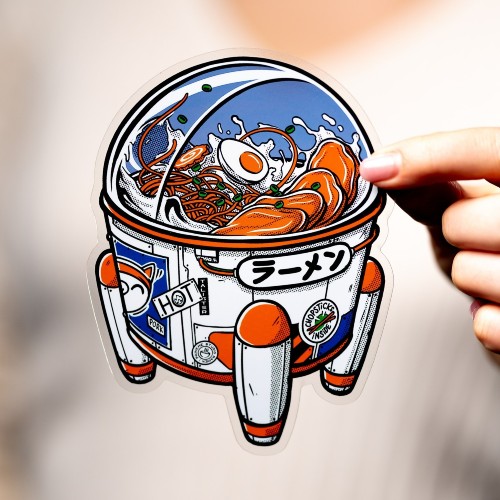 Sticker of a futuristic ramen bowl designed as a spaceship, featuring noodles, an egg, and Japanese text on the side.