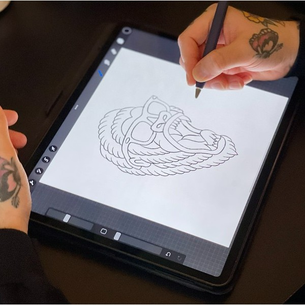 Person drawing a detailed illustration of a roaring lion wearing sunglasses on a tablet in Procreate