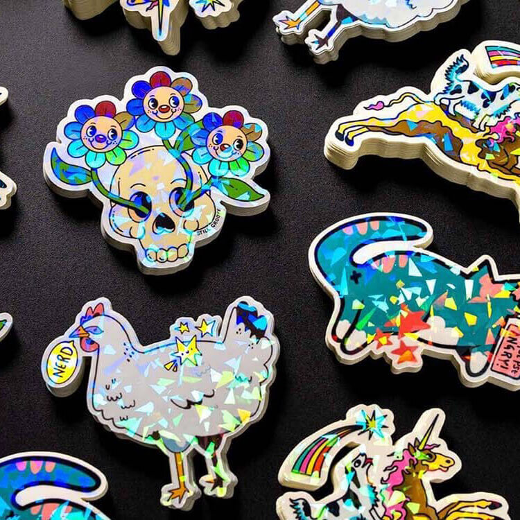 die cut stickers in stacks with cracked ice laminate laying flat on a table